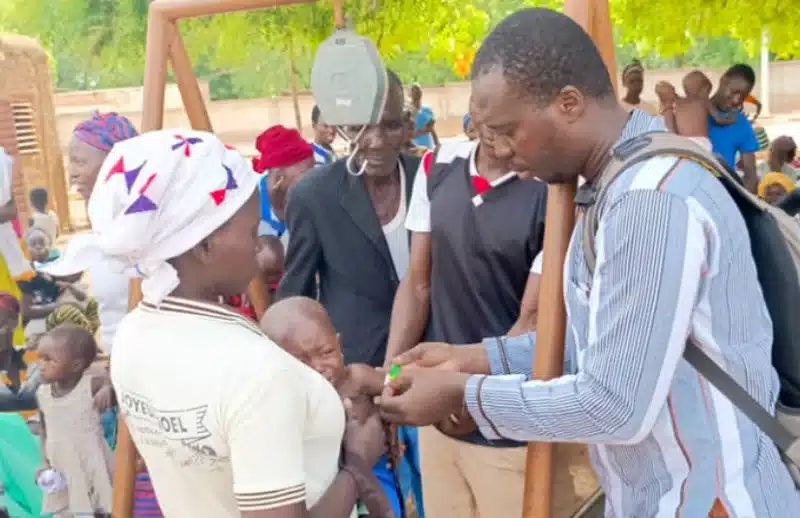 The head doctor at the Diapaga Medical Centre screening children for malnourishment